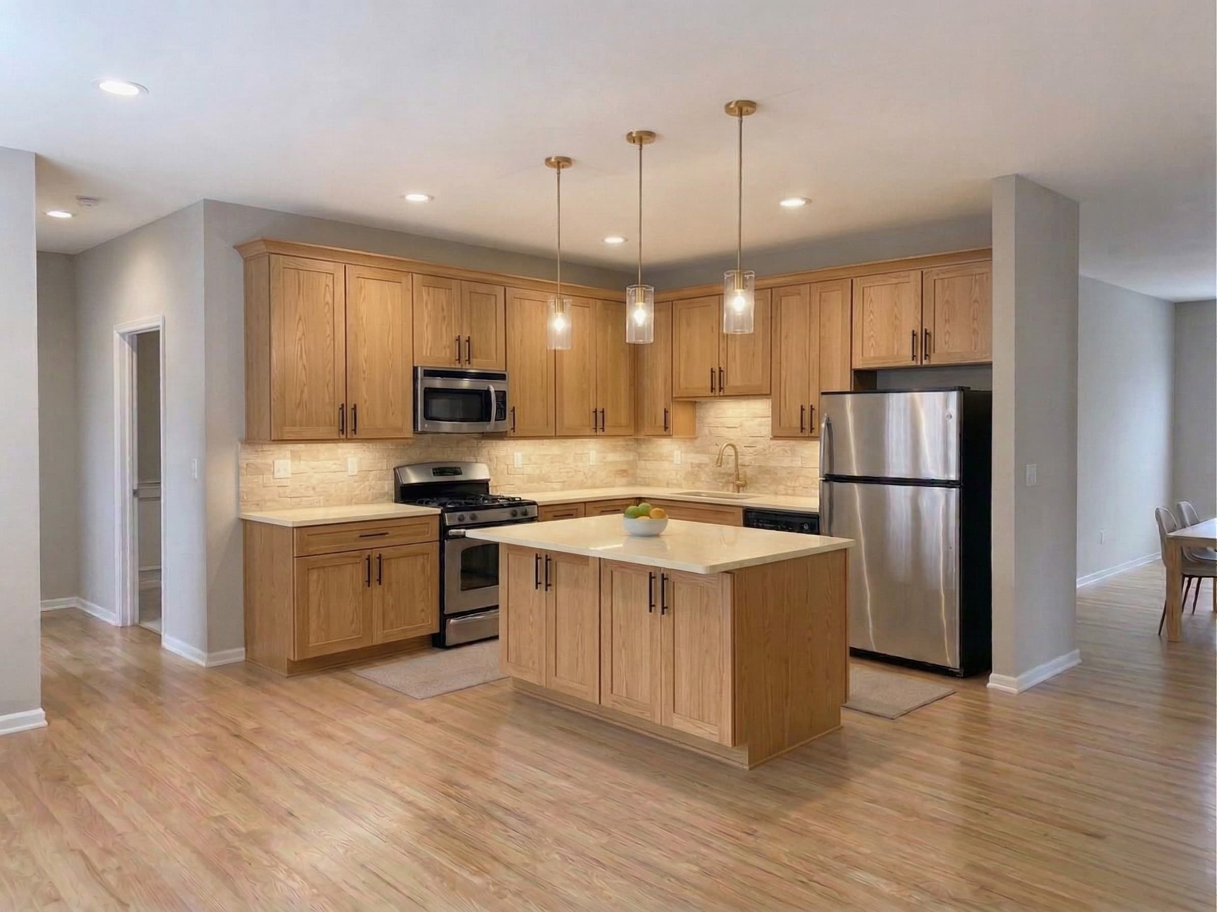 Natural Oak cabinet finish — Honey oak grain · Black hardware