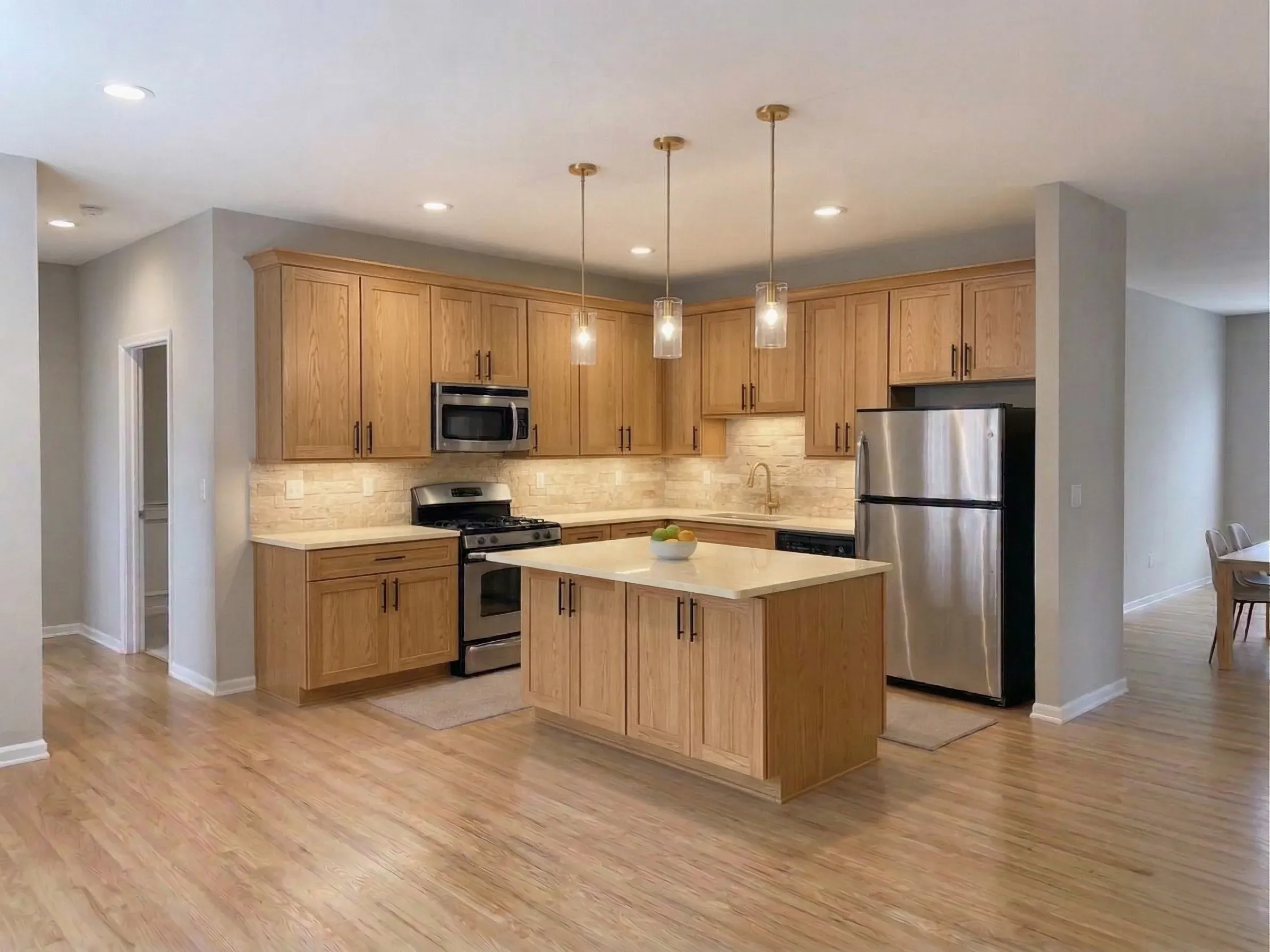 Natural Oak cabinet finish — Honey oak grain · Black hardware