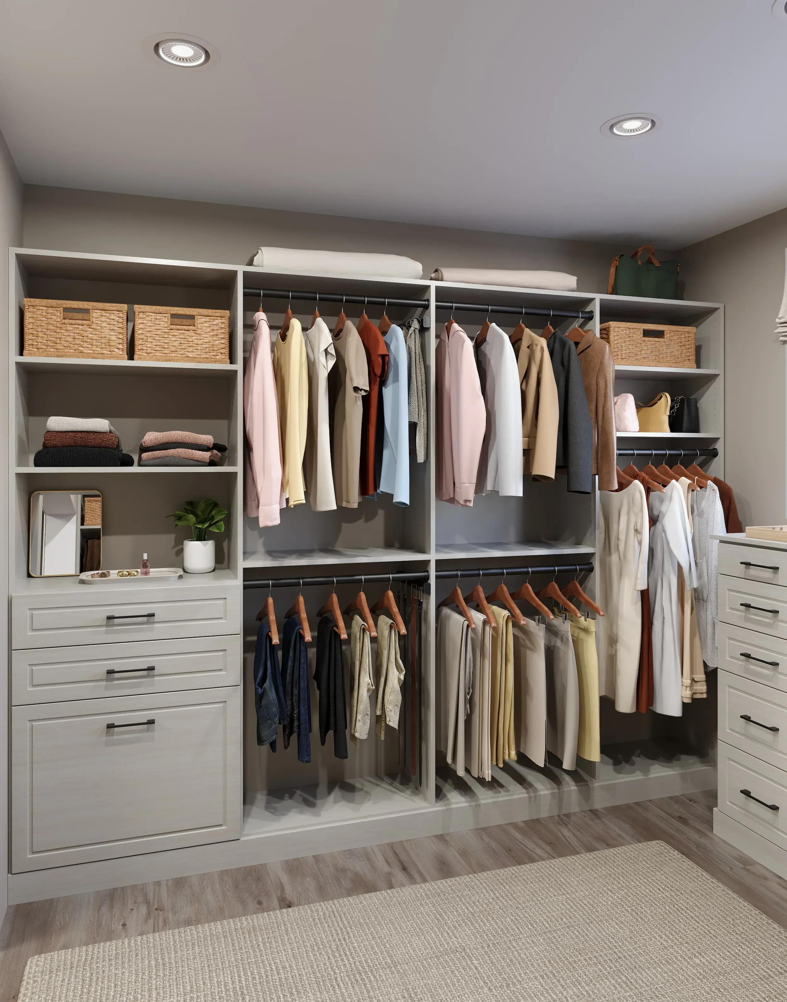 Walk-in closet system with hanging sections, open shelving, drawer bank and integrated lighting